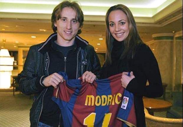Luka Modric poses with a personalised Barcelona jersey