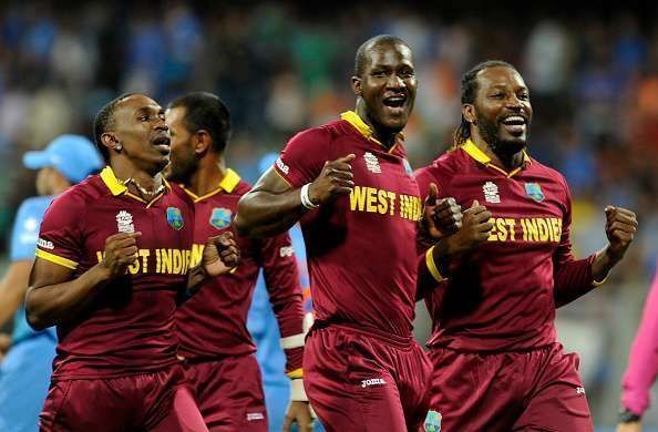 Darren Sammy (centre) and Chris Gayle (right)