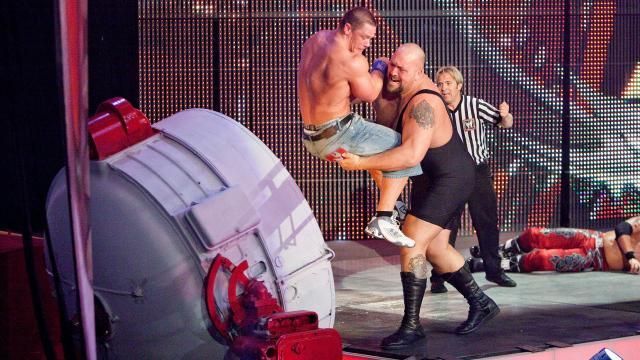 The Big Show chokeslamming Cena into a spotlight