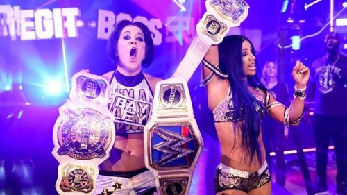 Sasha Banks and Bayley pose with the Women's Tag Championships