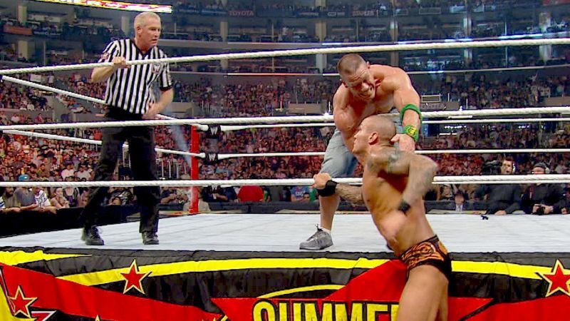 Randy Orton attempting the mid-rope RKO on John Cena