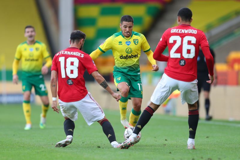 Emiliano Buendia takes on Bruno Fernandes and Mason Greenwood of Manchester United