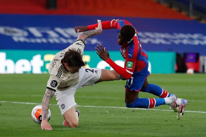 Victor Lindelof throws himself into a risky challenge against Wilfried Zaha