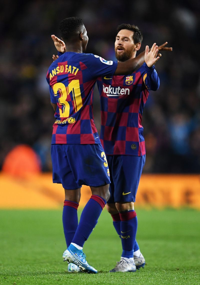 Lionel Messi celebrates a goal with Ansu Fati.