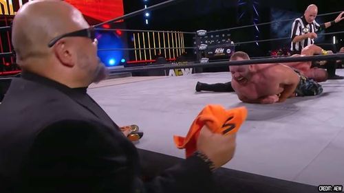 Brian Cage's arm gets yanked by Jon Moxley as Taz looks on nervously on AEW Fight For The Fallen