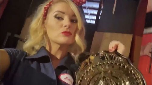 Lacey Evans with AJ Styles' Intercontinental Championship