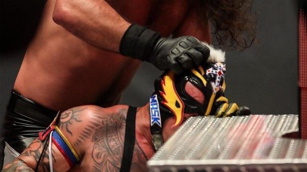 Seth Rollins rubbing Rey Mysterio&#039;s face against the steel steps,