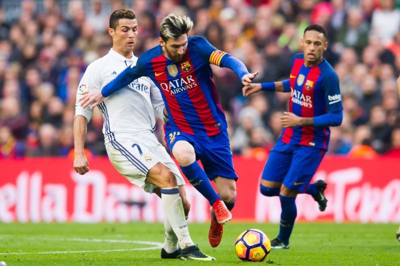 Lionel Messi (left-footed) and Cristiano Ronaldo (right-footed) duelling for the ball in an El Clasico