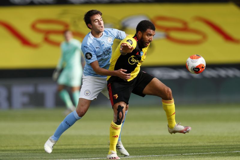 Eric Garcia tussles with Troy Deeney of Watford