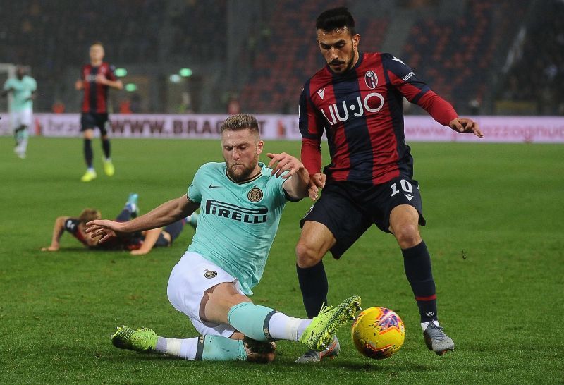 Milan Skriniar of FC Internazionale tackles Nicola Sansone of Bologna FC 