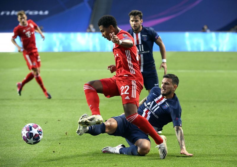 Leandro Paredes of Paris Saint-Germain tackles Serge Gnabry 