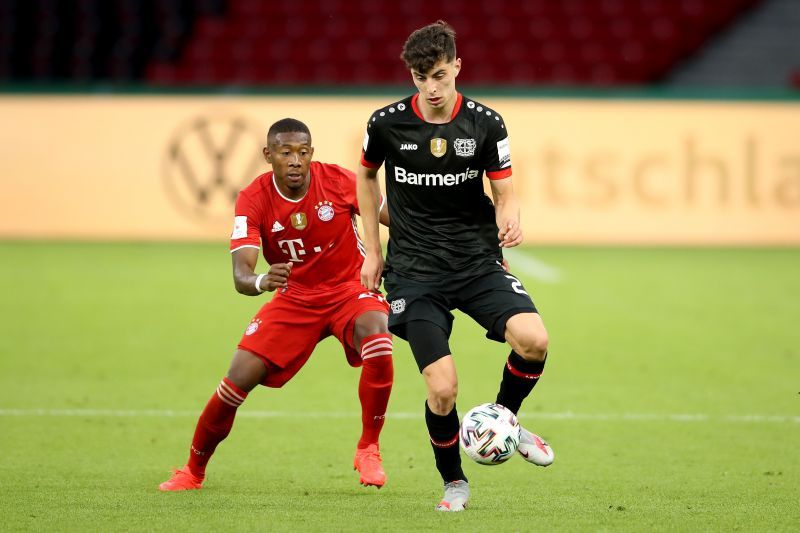 David Alaba (L) of Bayern Muenchen battles for the ball with Kai Havertz of Leverkusen