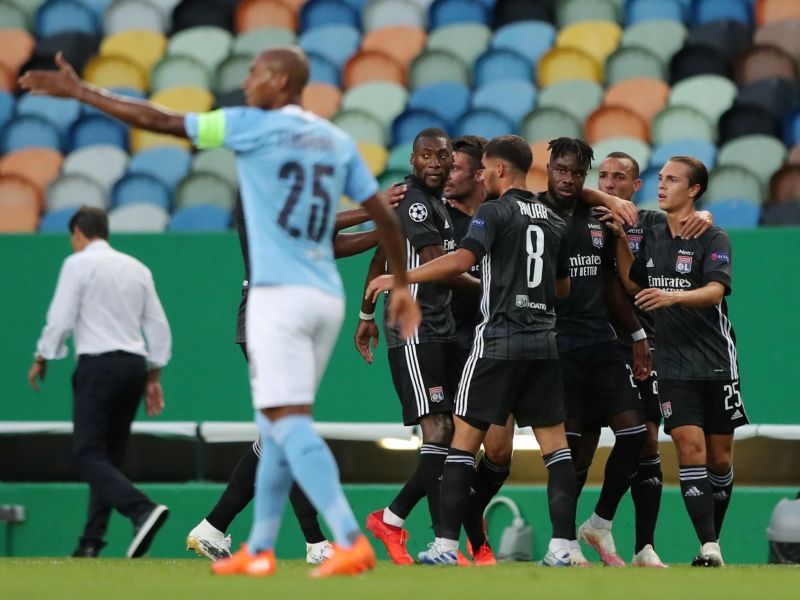 Lyon players celebrating a goal against Manchester City.