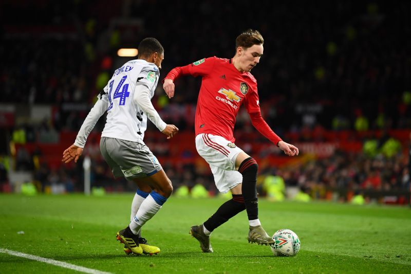 James Garner of Manchester United battles for possession with Brandon Comley of Colchester United