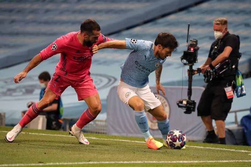 David Silva is challenged by Dani Carvajal of Real Madrid during the UEFA Champions League.