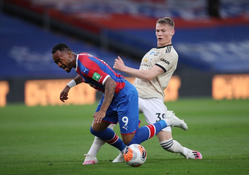 Jordan Ayew of Crystal Palace is tackled by Scott McTominay of Manchester United