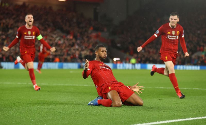 Georginio Wijnaldum of Liverpool celebrates with Jordan Henderson and Andy Robertson after scoring