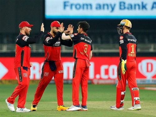 RCB players celebrate after the fall of a wicket. (Image Credits: Times of India)