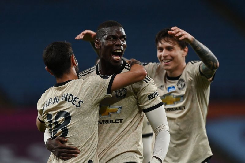 Paul Pogba celebrating a goal with Bruno Fernandes (left) and Victor Lindelof (right)