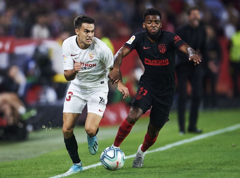Sergio Reguilon of Sevilla FC duels for the ball with Thomas Lemar of Club Atletico de Madrid