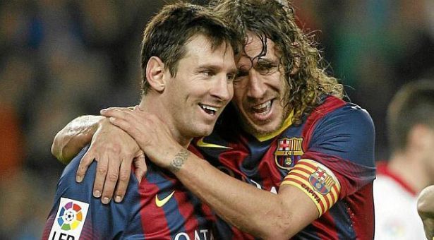 Lionel Messi (left) with former Barcelona player Carles Puyol (right)