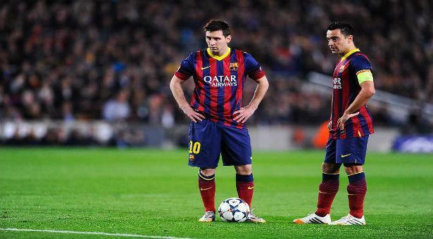 Xavi (left) and Lionel Messi