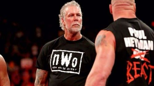 Kevin Nash staring Brock Lesnar down.