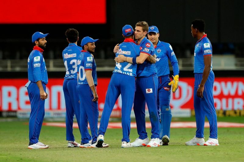 Delhi Capitals players celebrate the fall of a wicket.
