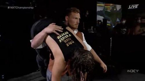 Ridge Holland carries Adam Cole to the ringside area where he dumps him at NXT TakeOver 31 after the main event between Finn Balor and Kyle O'Reilly