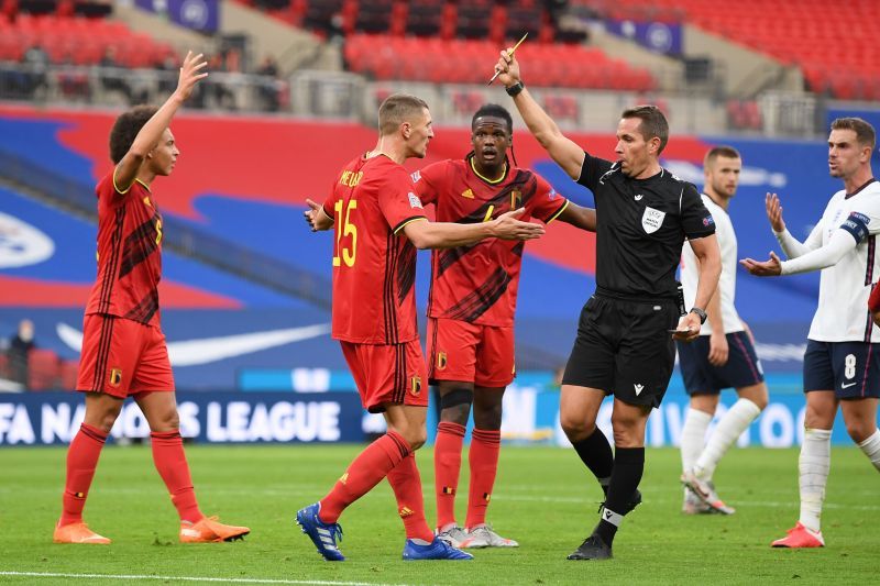 Thomas Meunier is shown a yellow card for bringing down Henderson inside the area
