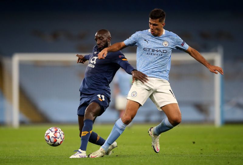 Moussa Marega battles for possession with Rodrigo.