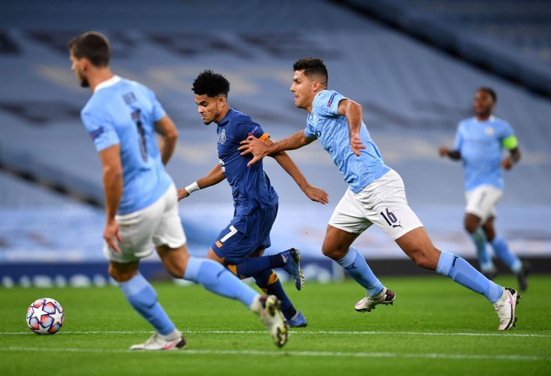 Luis Diaz runs with the ball past Rodrigo on his way to score his side's first goal.