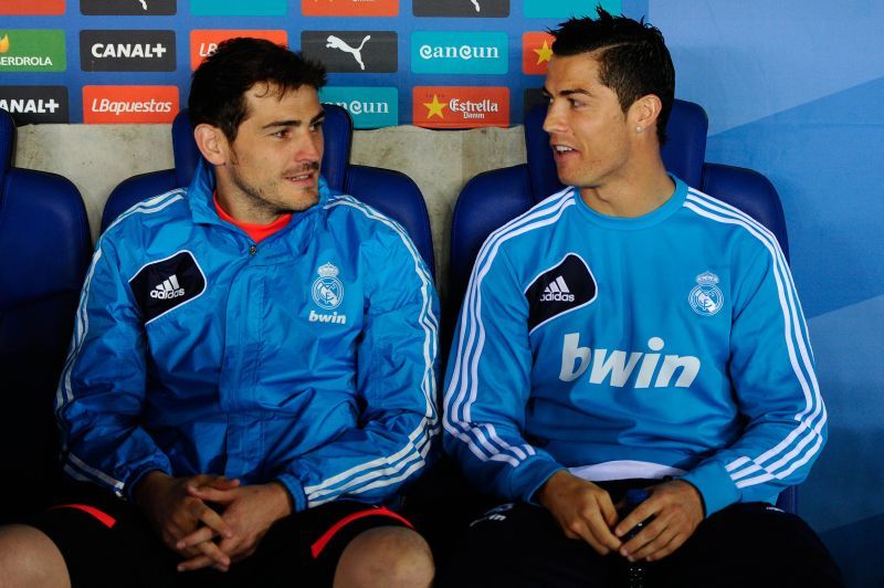 Iker Casillas sits with Cristiano Ronaldo on the Real Madrid bench