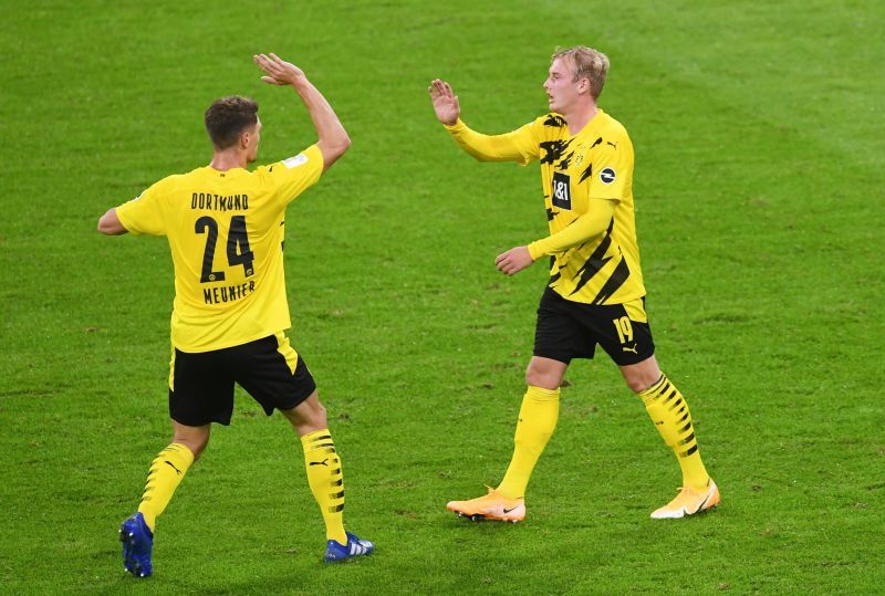 Julian Brandt celebrates scoring their first goal with Thomas Meunier during the game.