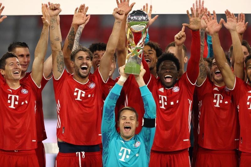 Manuel Neuer of Bayern Munich lifts the Supercup 2020 as he celebrates with his teammates.