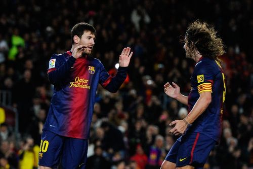 Barcelona's past and present captains Leo Messi and Carles Puyol