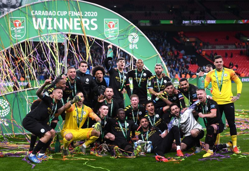 Manchester City players pose with the Carabao Cup