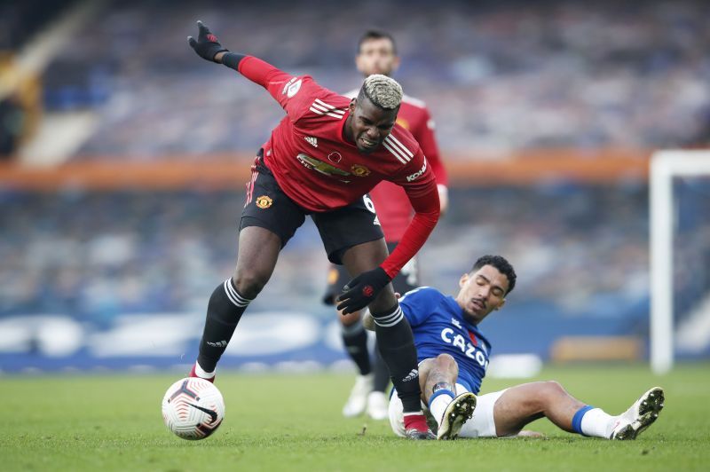 Paul Pogba of Manchester United is challenged by Allan of Everton