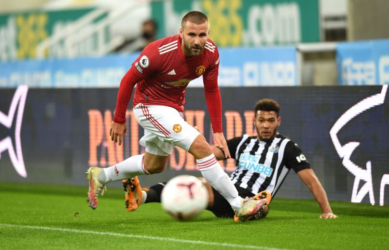 Manchester United's Luke Shaw beats Joelinton to the ball.