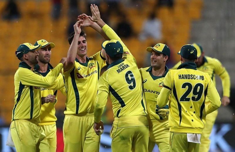 Pat Cummins celebrates a wicket with Australian teammates