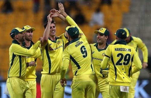 Pat Cummins celebrates a wicket with Australian teammates