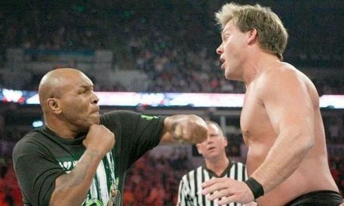 Mike Tyson is about to punch Chris Jericho in WWE during the match between the Unified WWE Tag Team Champions D-Generation X and Chris Jericho's team with Mike Tyson