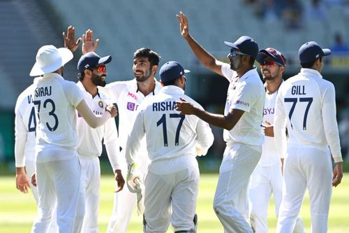 Jasprit Bumrah celebrates with his teammates after dismissing Mitchell Starc in the first innings