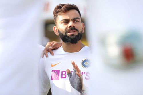 Virat Kohli talking during a team huddle