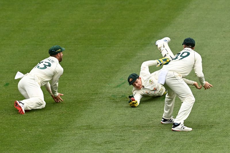Tim Paine dived low to complete a stunner off Pat Cummins to dismiss Cheteshwar Pujara.