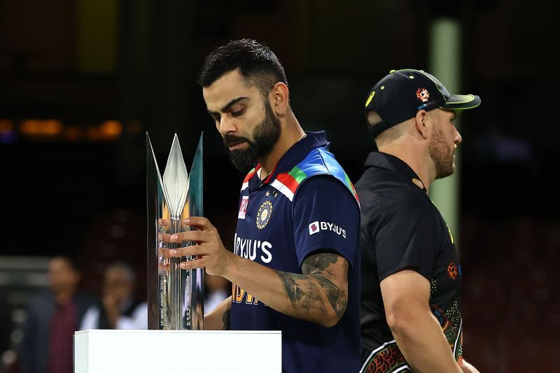 Virat Kohli holds the T20I trophy.