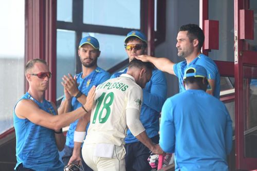 Teammates pat Du Plessis as he returns to the dressing room after being dismissed for 199