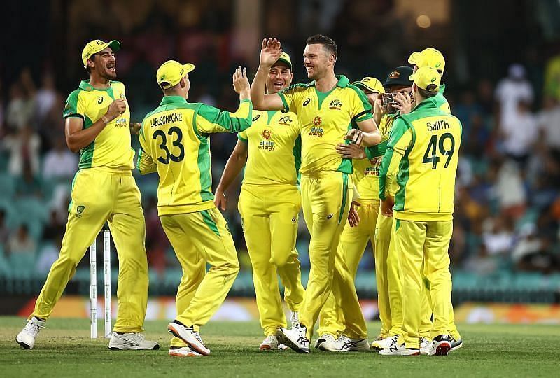 The Australian team celebrate after picking up a wicket.