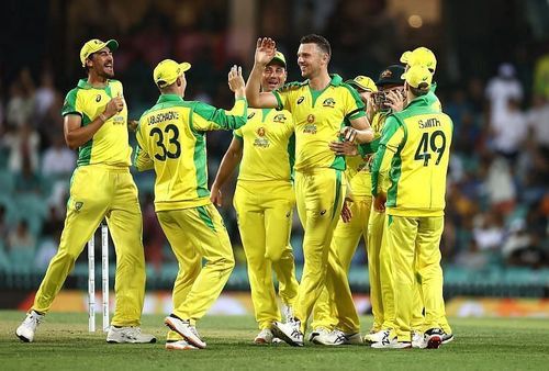 The Australian team celebrate after picking up a wicket.