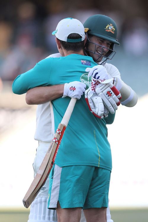 Joe Burns hugs Australian coach Justin Langer after Australia's win in the Adelaide Test.